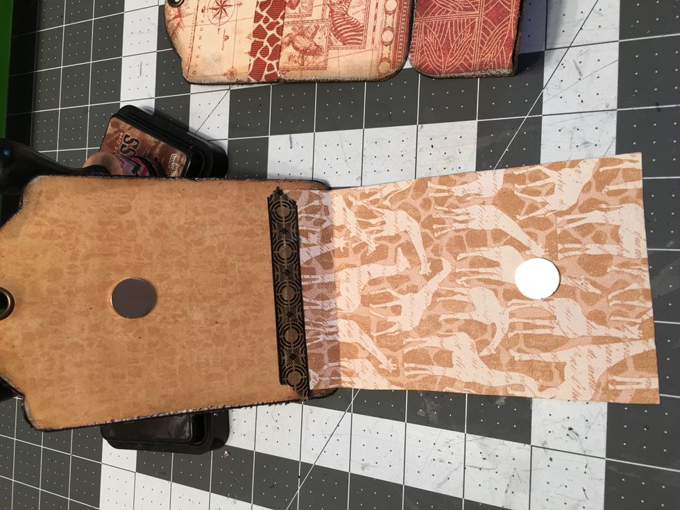 Gently open up the flap, separating the two magnets. You will now have a magnet on each side as shown.