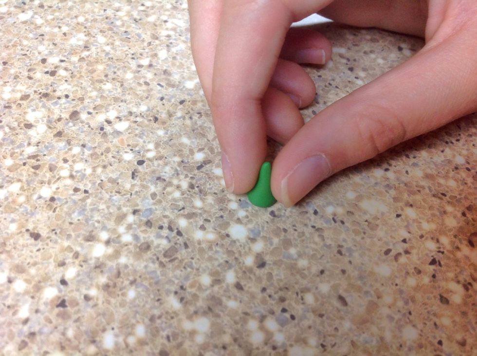 Gently pick the cone shape up and flatten the larger end of the cone on the hard surface.