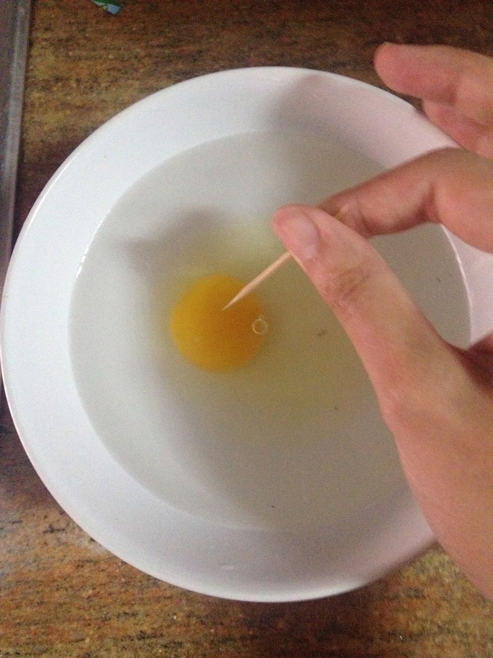 Gently pierce the yolk with a toothpick