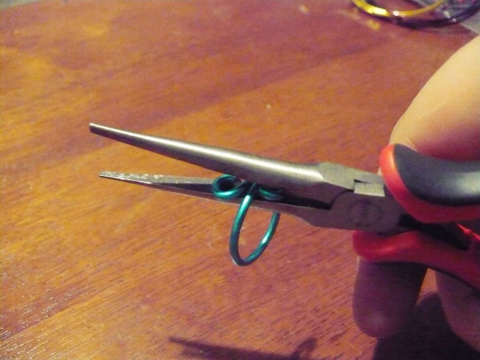 Gently pinch on both sides. This aligns the wire so that the loops are straight, and so no toes go scratched by loose ends sticking out. . . COMPLETE! Th next step is optional. Peace out. \u270c