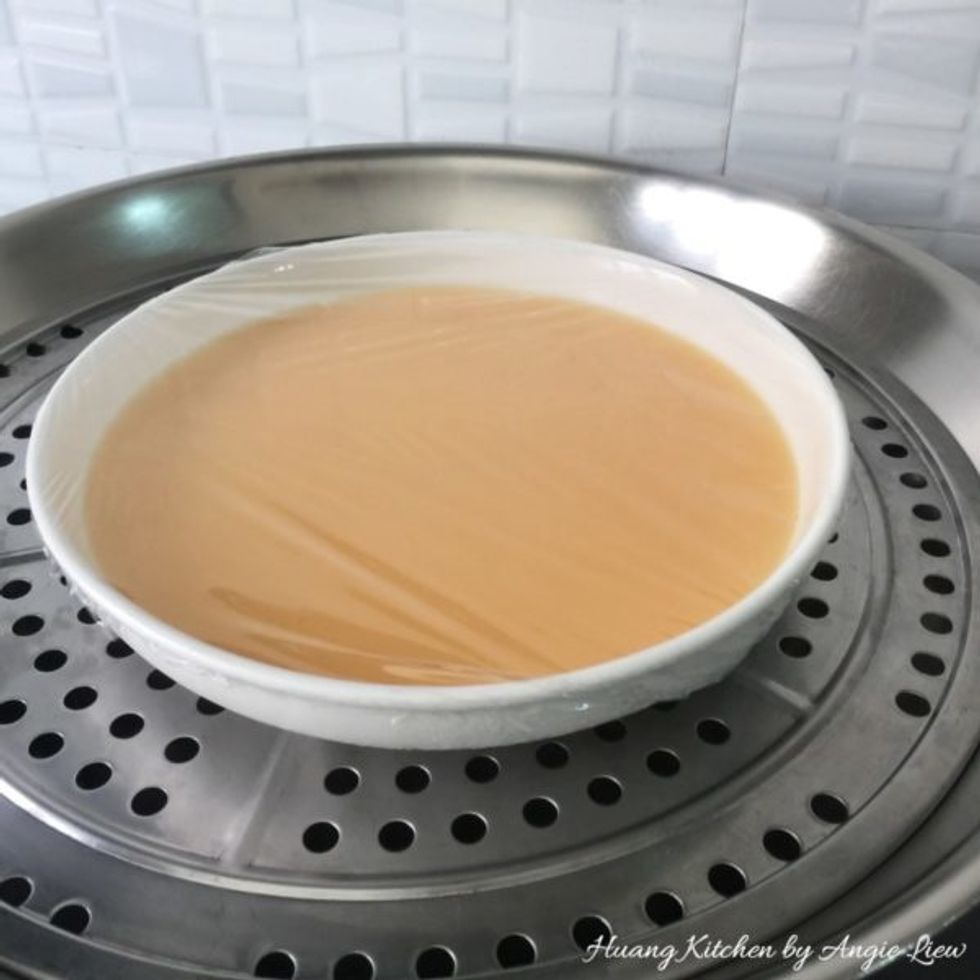 Gently place the bowl onto a prepared steamer.