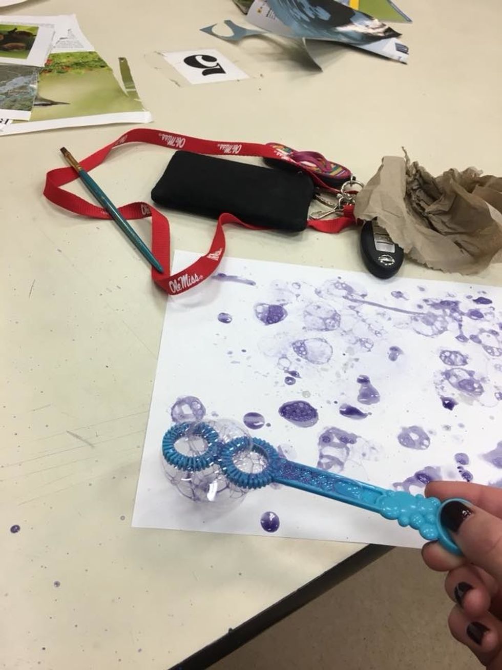 gently place the bubbles against the piece of paper with enough pressure so they pop, the more careful you are with this step the more detailed the bubbles will be