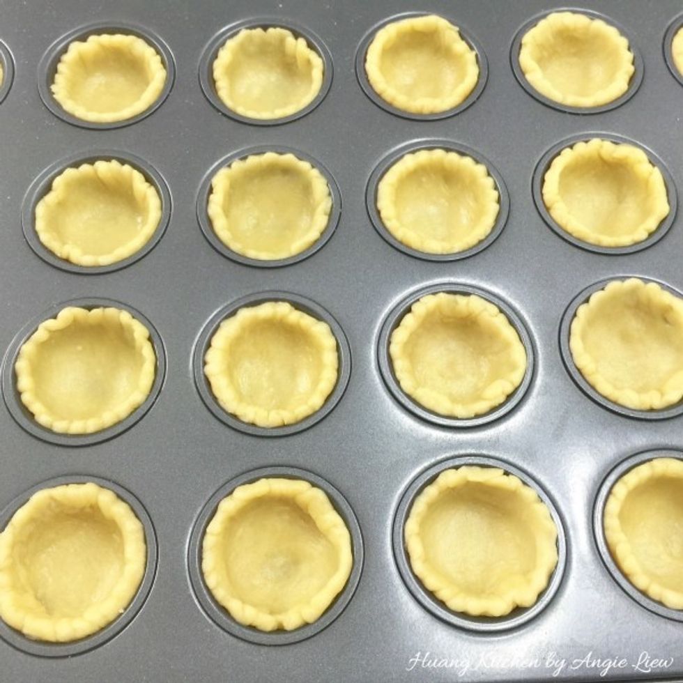 Gently place the cut rounds into the muffin cups. Try not to pull too much the pastry. Otherwise it will shrink while baking.