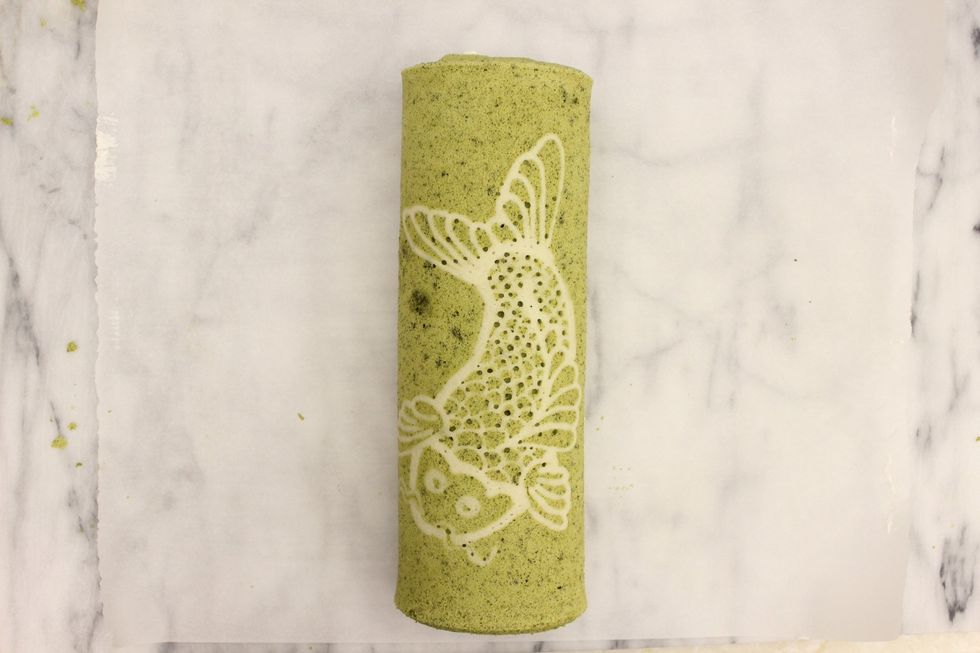 Gently place the roll on the center of the parchment paper.