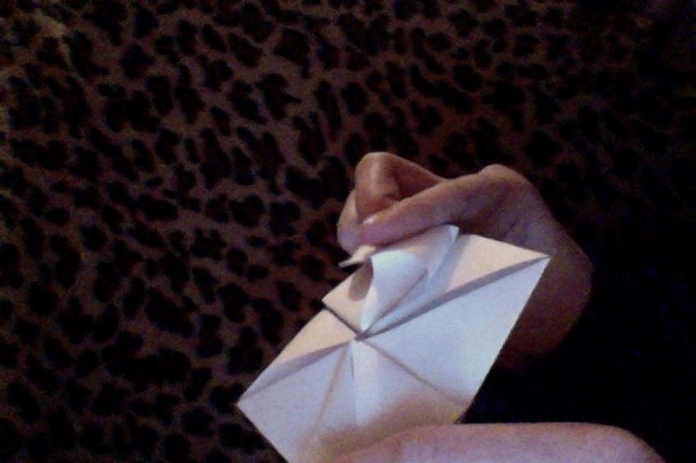Gently press down on the top of this pocket, and flatten it into a small square.