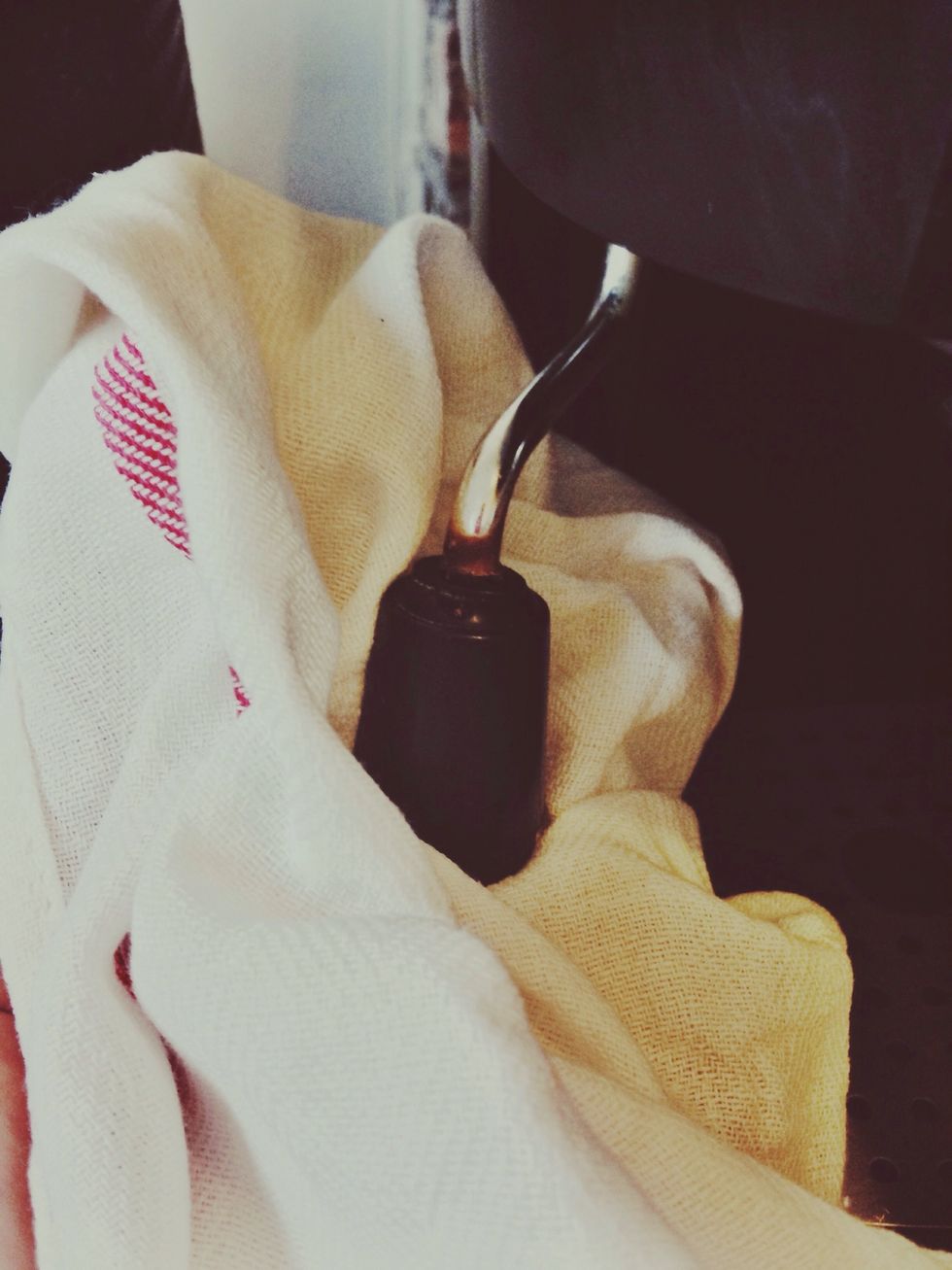 Gently pull pitcher off wand with towel in hand. Always clean off steam wand!! This will save headaches of clogged steam wands in the future.