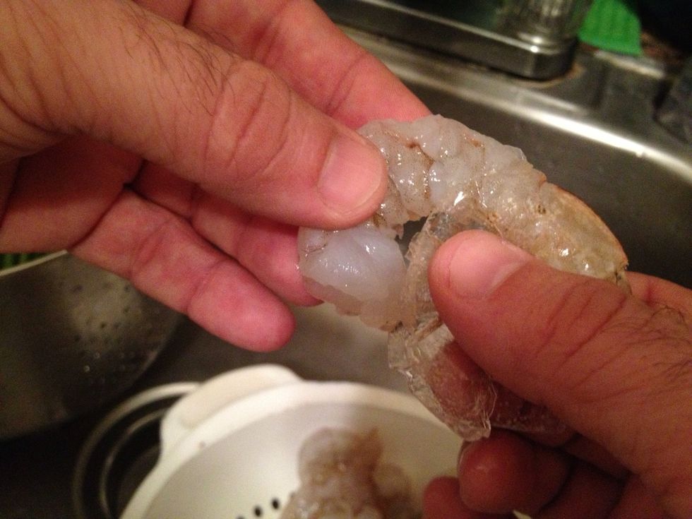 Gently pull the legs off the shrimp from the middle of the shrimp first.