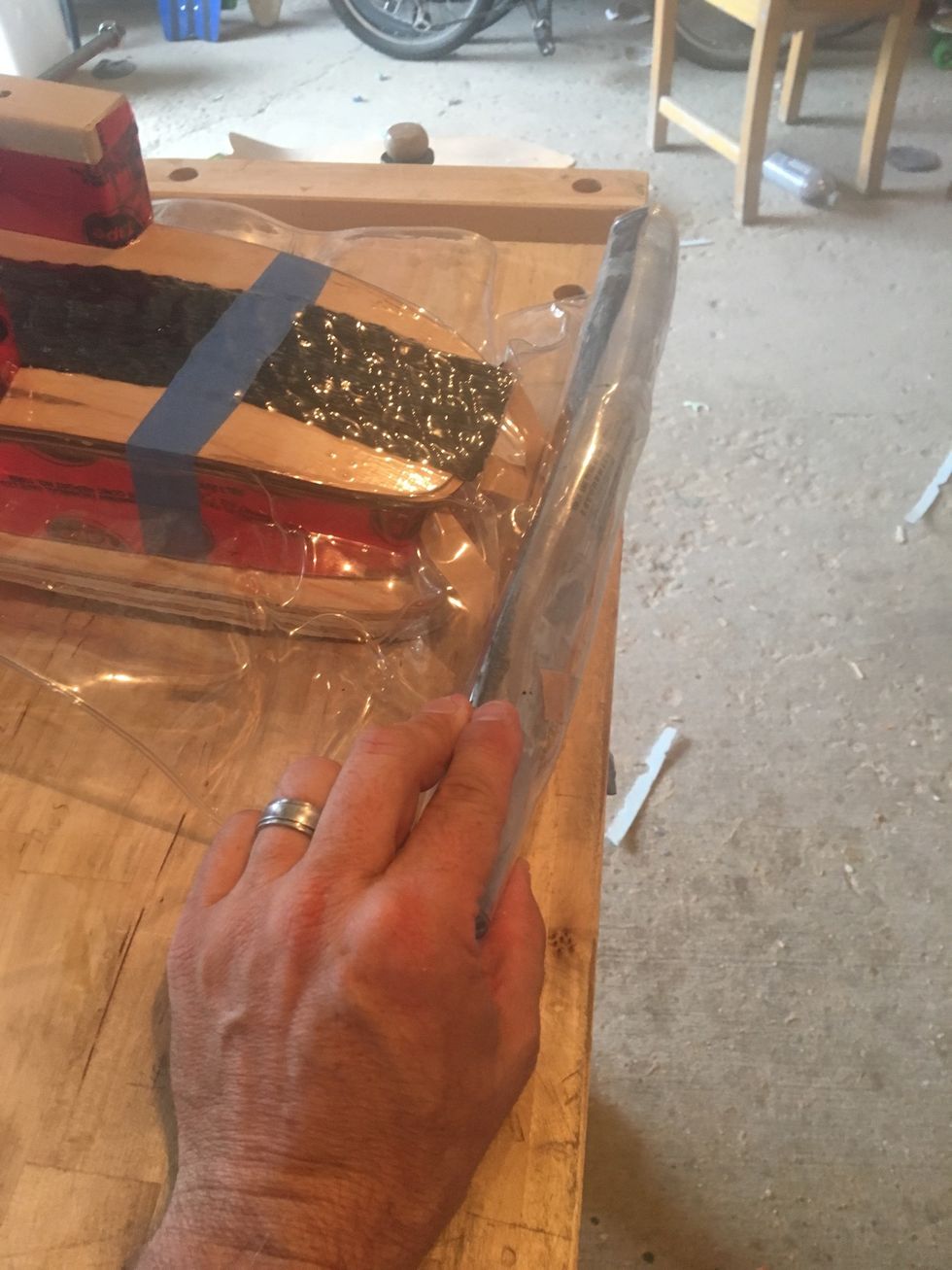 Gently roll up vacuum bag on the tail end.