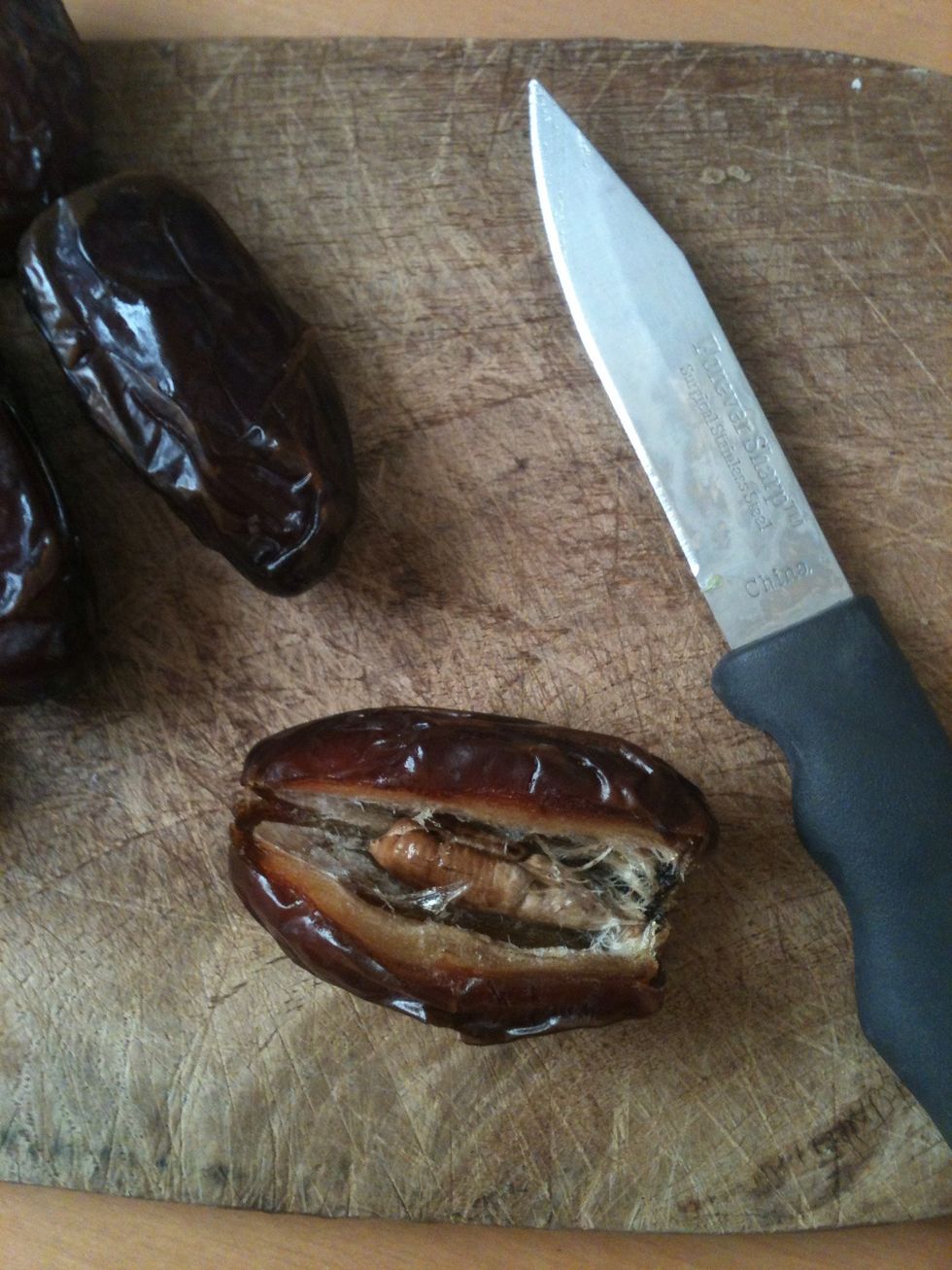 Gently slice top of date lengthwise.