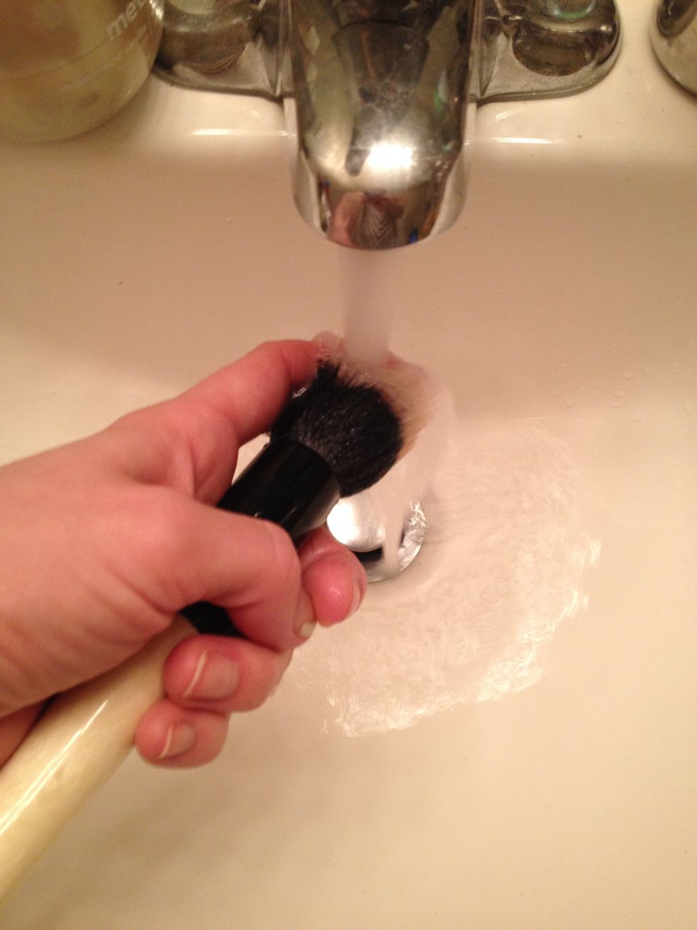 Gently use a finger to rub the brush hair to help loosen any stubborn build up.  Remember to keep the brush angled downward as much as possible.