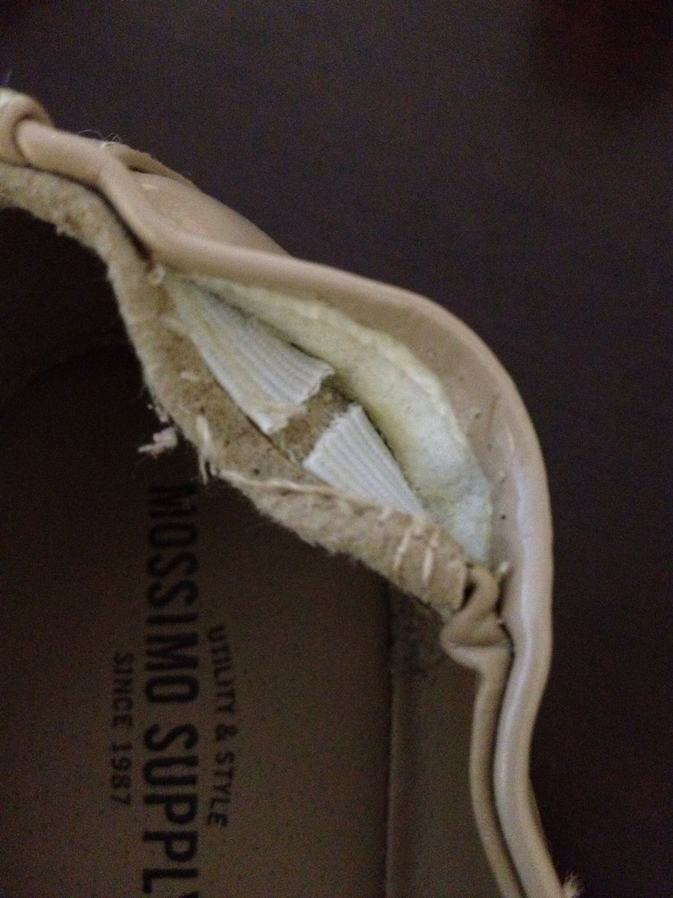 Gently, use your seam ripper to slice the elastic- all the way from the top to the bottom edge. Repeat on the other side of the shoe.