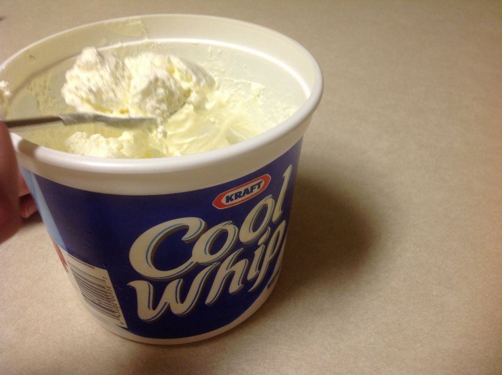 Get 1 spoonful of cool whip. Put it in the blender. The cool whip is optional.
