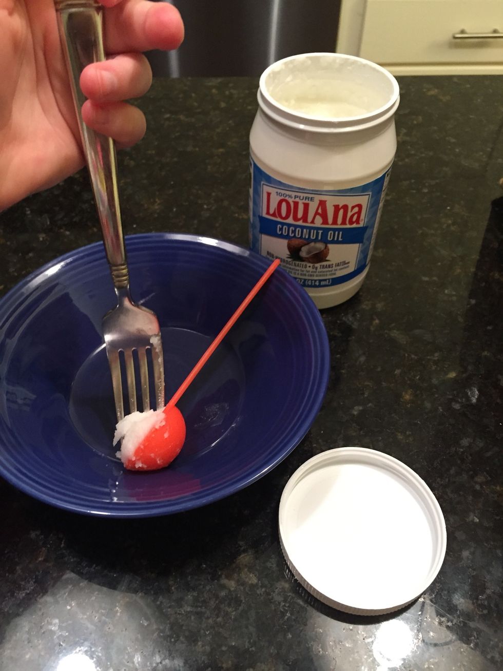 Get 2 tablespoons of coconut oil and get the excess into the bowl with a fory