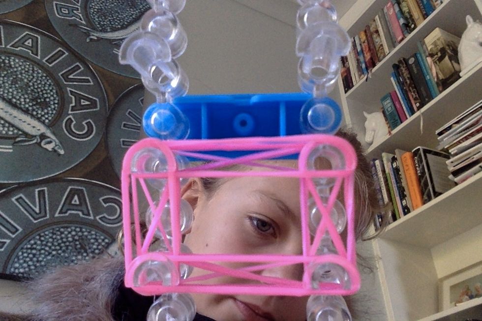 Get 4 more pink rubber bands and stretch them around a 1st peg to second all the way to the start.