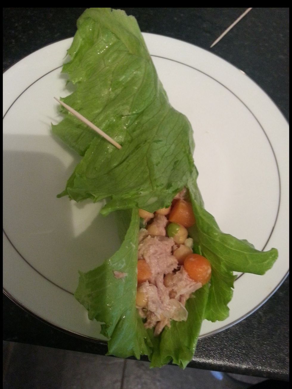 Get a big piece of lettuce and add in your mixture of veg tuna and chickpeas. Stick In a cocktail stick to keep the contents gathered