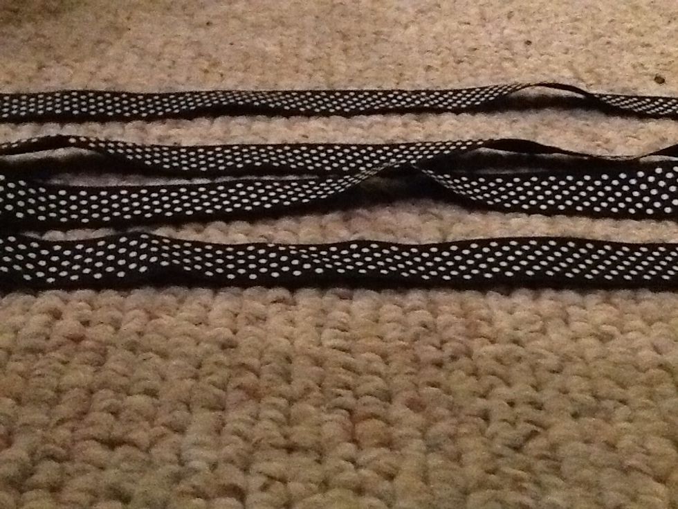 Get a black ribbon with white polk a dots