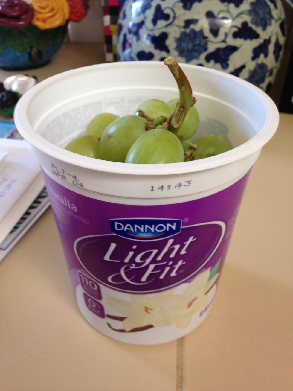 Get a bunch of grapes and freeze them. This is only if you want a fun snack to go with the milkshake! Wait until they are pretty hard. They can be any color you want! I am using green.