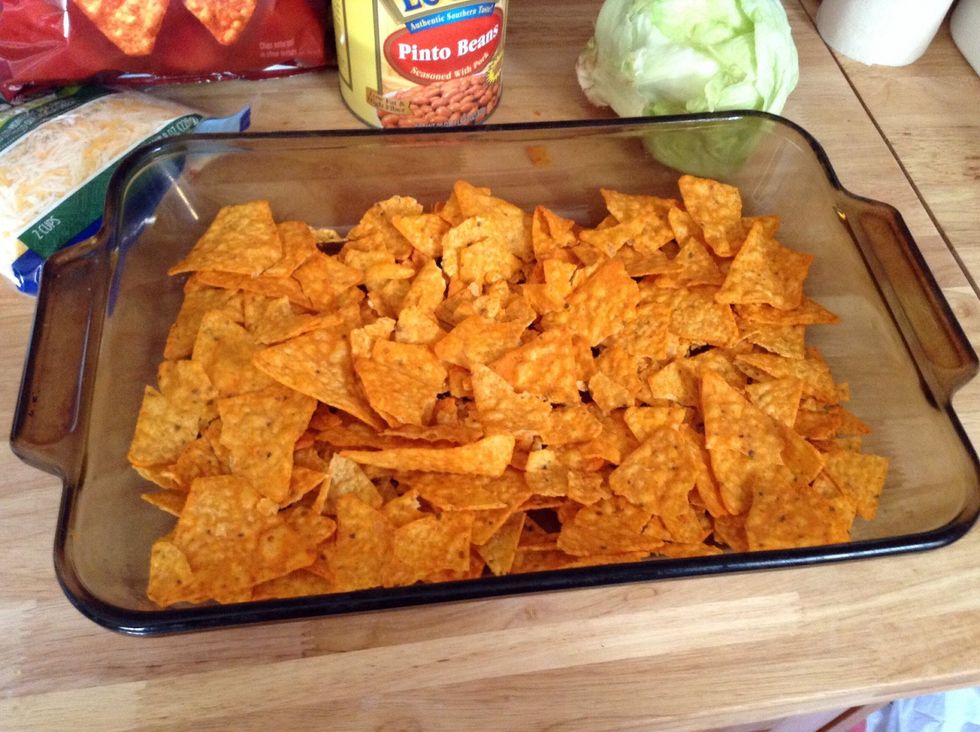 Get a casserole pan and lay out the Doritos in it. I cover up the bottom of the pan then kinda of break them