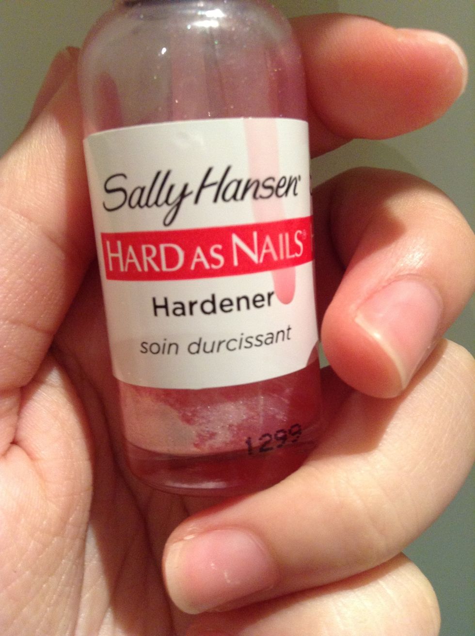 Get a clear or a light pink shade( I used a super shiny hardener with added red polish, gold/pink eyeshadow to make it slightly sparkly) and paint over the nail. This step can be left out completely.