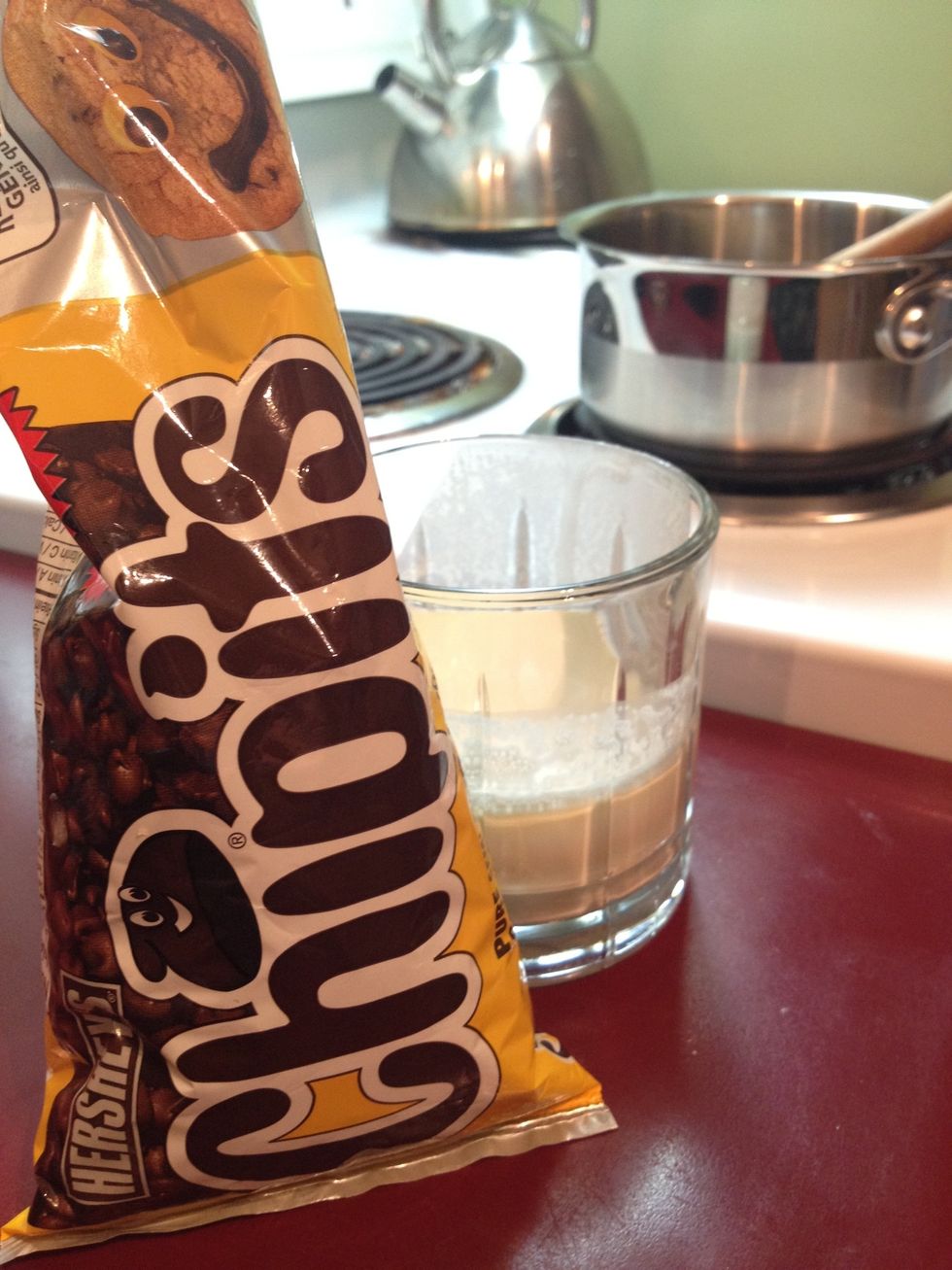 Get a couple hand fulls of chocolate chips and just a bit of whipping cream to melt in a pot...