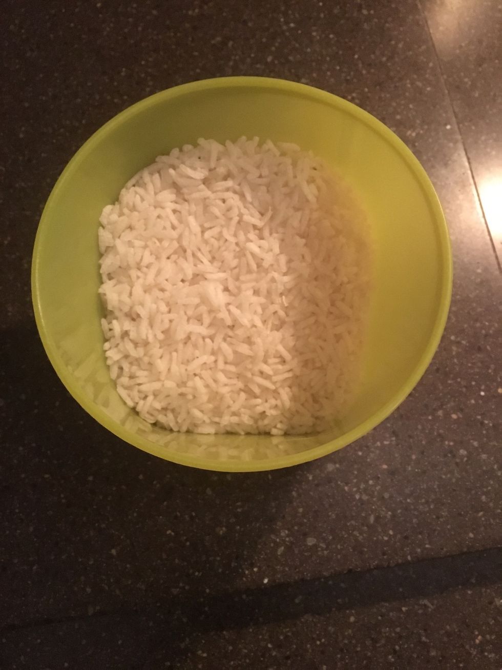 Get a cup of rice ready to cook. This is done by boiling water then adding the rice while it is off the burner. After 5 minutes the rice is ready.