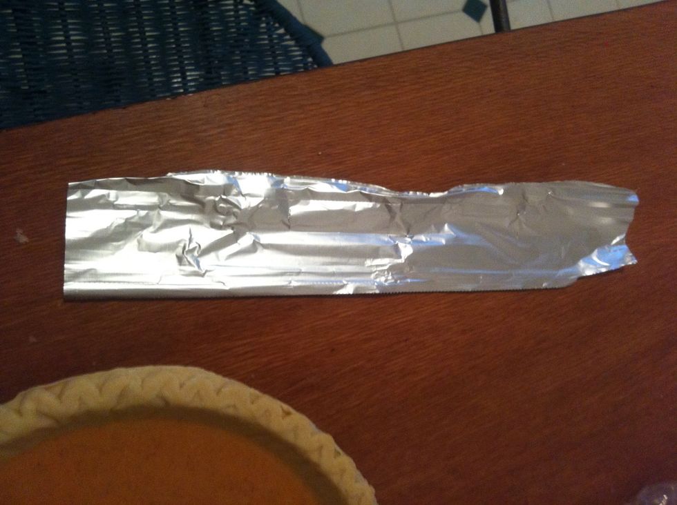 Get a few small strips of foil. About 3 for a 9" pie crust.