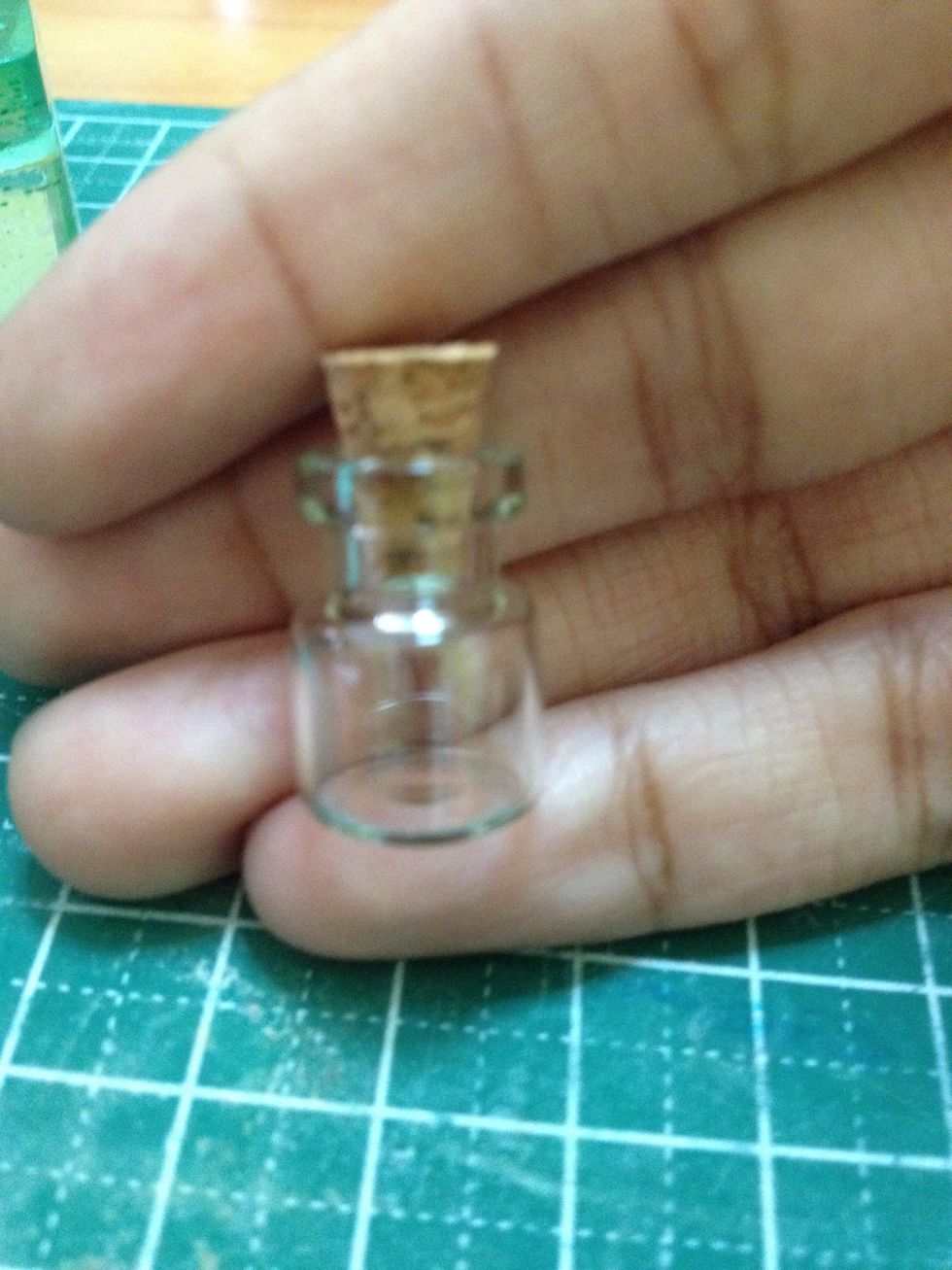 Get a glass jar with a cork on it, so if you want to add an eye pin you can insert it on top. Any size bottle is okay, that is if you can handle making whatever size ornaments.