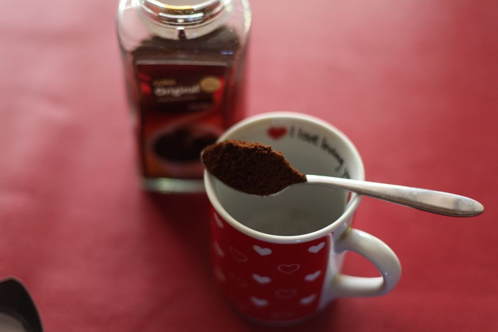 Get a heaped... And I mean heaped teaspoon of coffee. And your favourite I love you cup and add the coffee. Add more or less as you please.