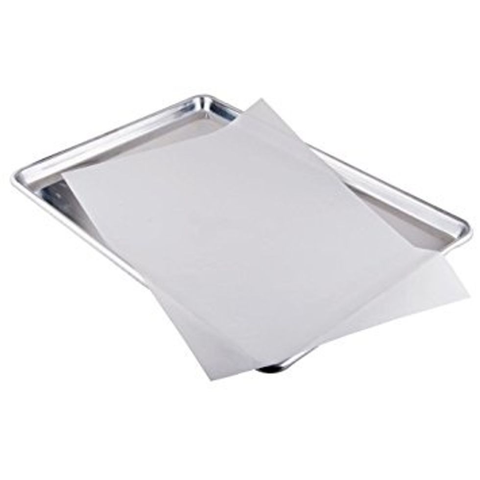 Get a large cookie pan and place a piece of parchment paper the size of the pan and put it on so it fits the pan.