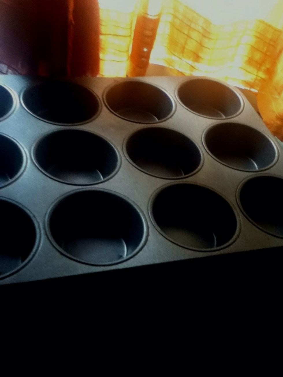 Get a muffin tray and grease them with butter