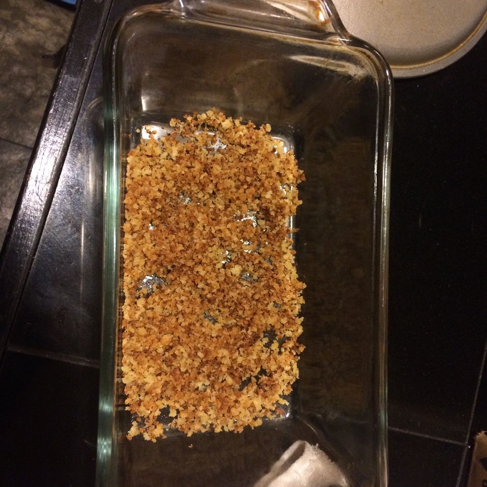 Get a pan, put some of the breadcrumbs on the bottom