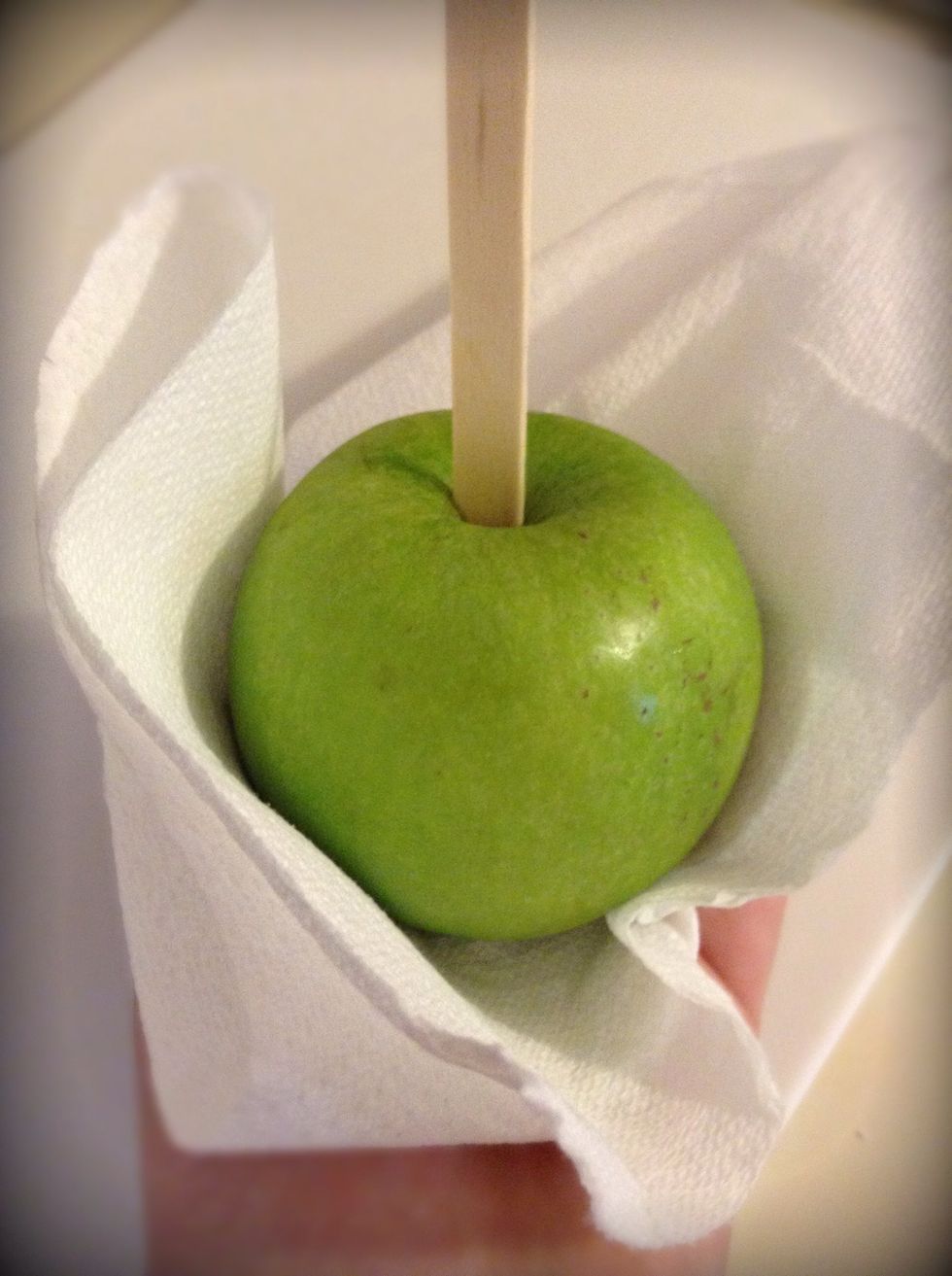 Get a paper towel and wipe off any water that might be on the apples. This is also important, if there is water on the apples the caramel won't stick properly.