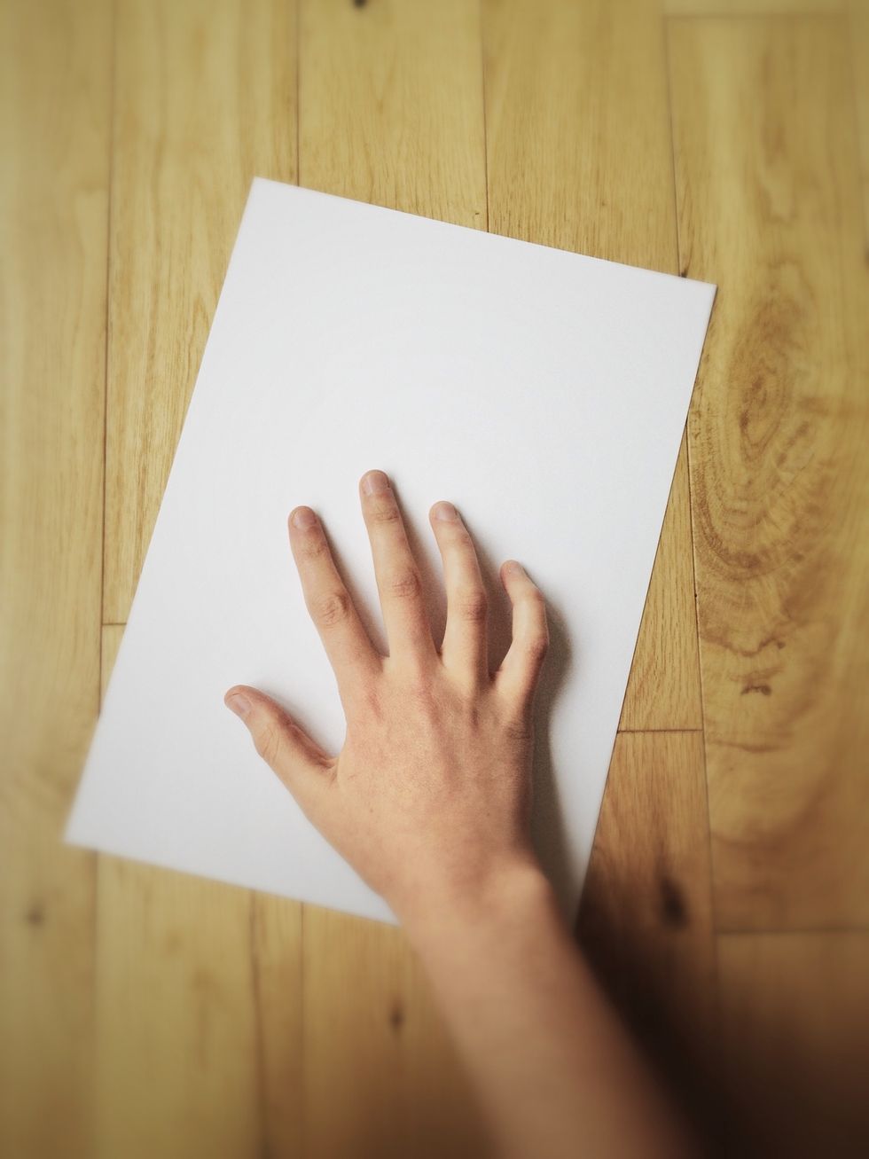 Get a rectangular sheet of thick paper (over 150gsm) or cardboard. Exact dimensions & crooked edges don't matter. Anything goes from nice colored card to simply cutting out the side of a cereal box.
