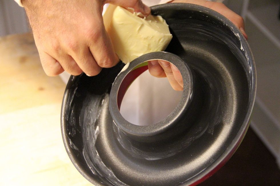 Get a round pan for cakes and spread your butter