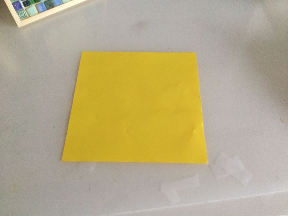 Get a sheet of square paper with the patterned paper facing down.
