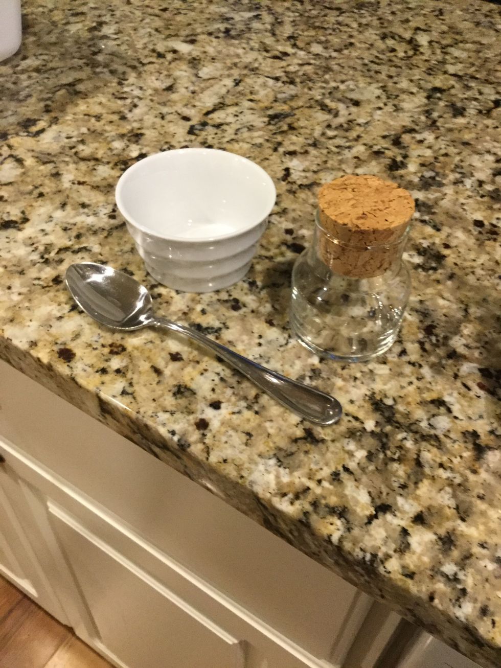 Get a small bowl, a container, a spoon, and the ingredients listed in the supplies section below.