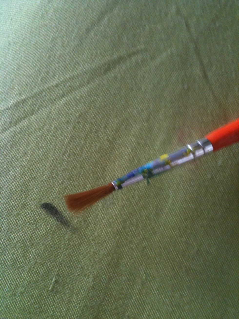 Get a soft old paint brush. Wash it with warm water and soap