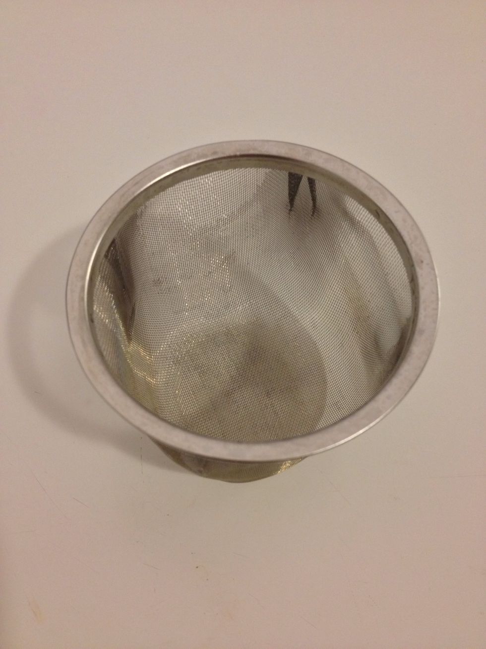 Get a strainer or sieve and put it over a mug.