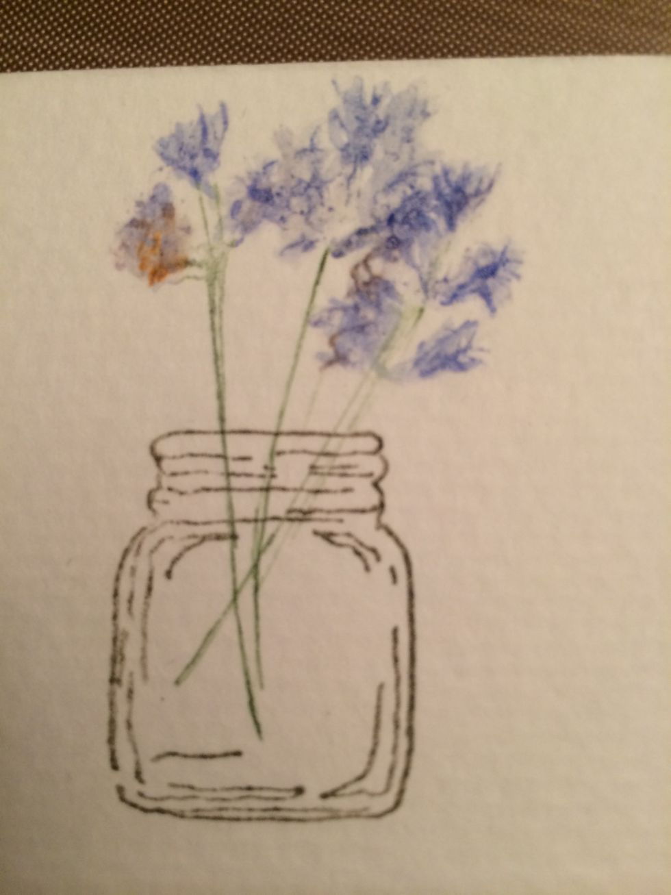 Get a tiny bit of water on your brush and with tiny quick strokes, blend the flowers