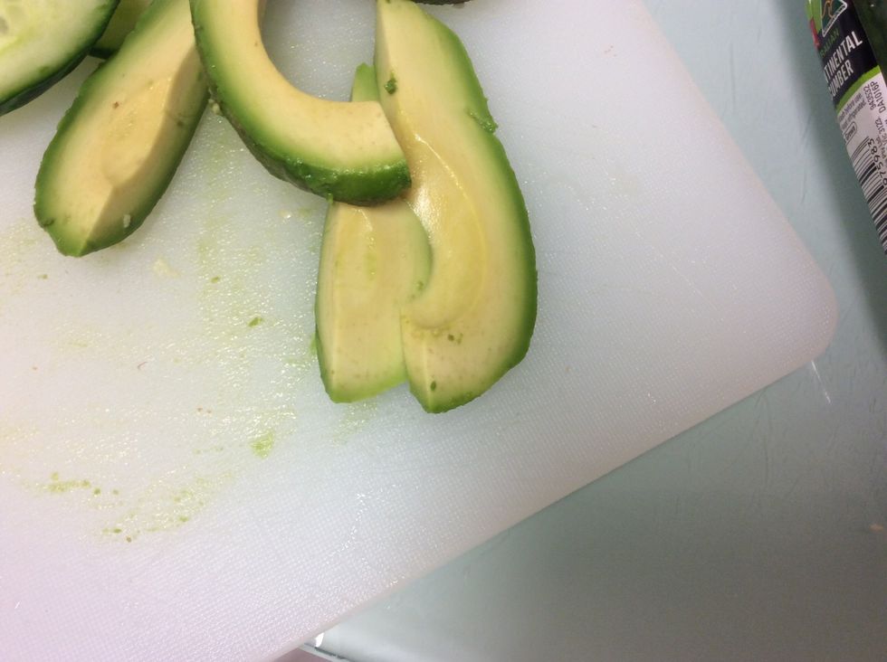Get a whole avocado and open it, take the seed out and cut into slices