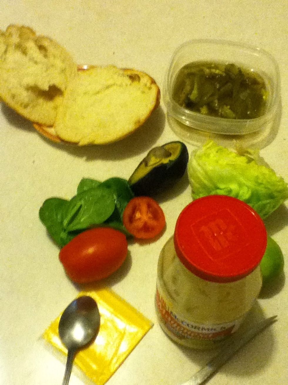Get all your supplies your going to use. Im using bread, tomato, avacado, spinich, lettuce, slice of cheese, mayonnaise, and dill jalape\u00f1os.