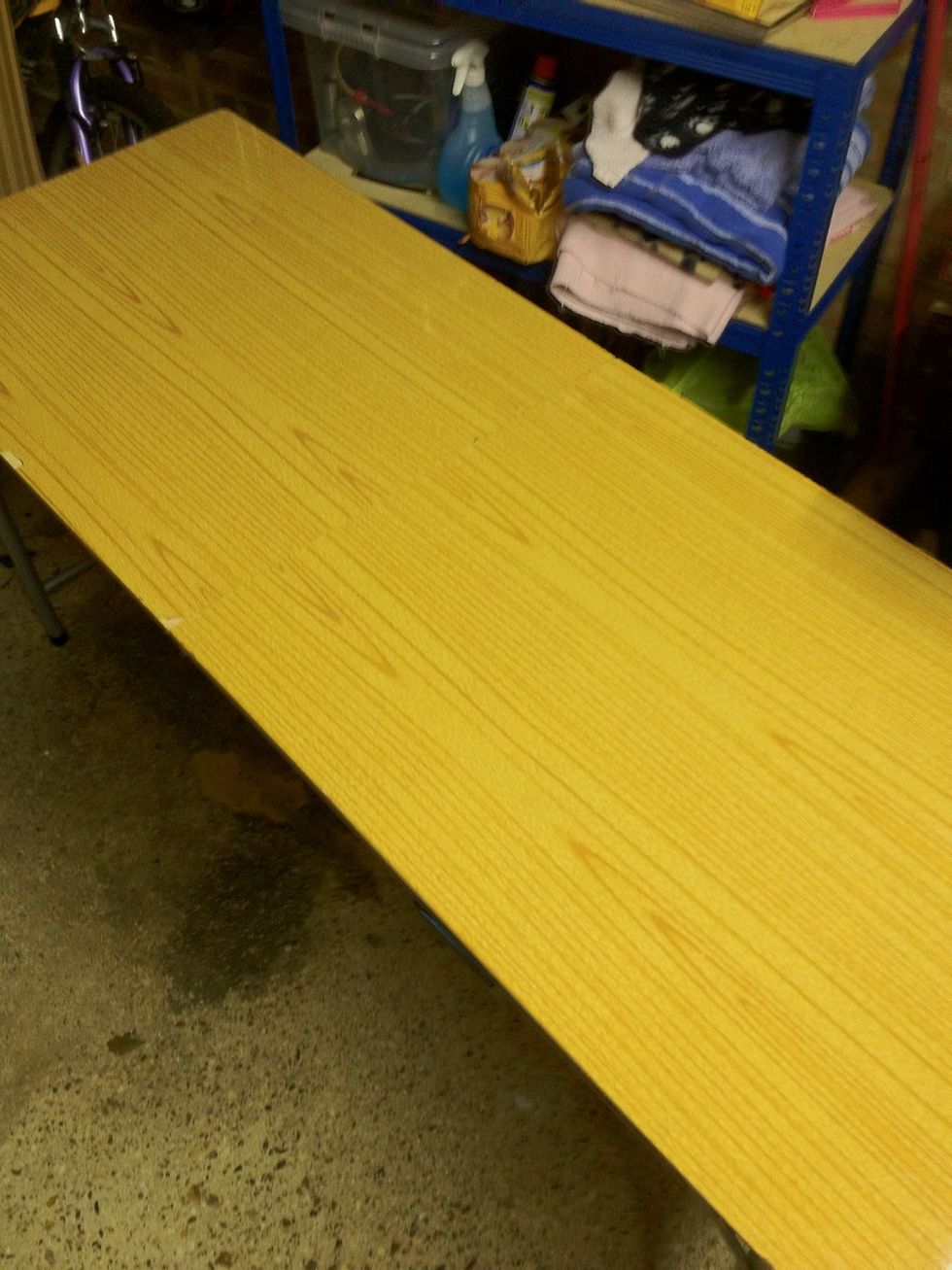 Get an area ready to spray. I'm using this wallpapering table in my garage, but you could do it outside too. Lay down some newspaper and make sure you move anything that could get painty.