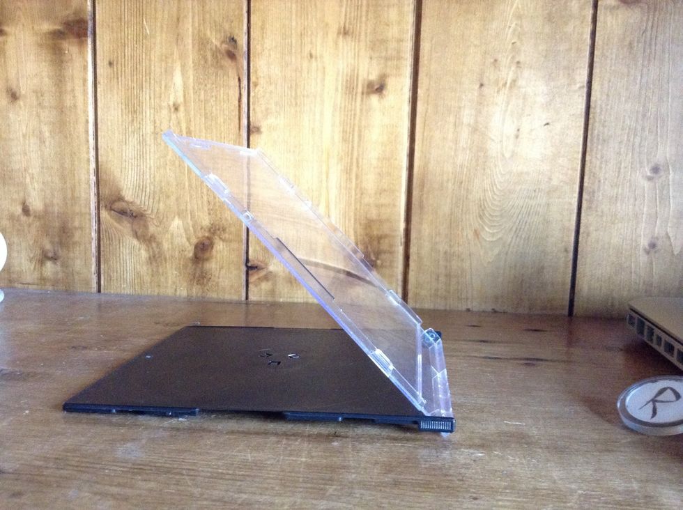 Get an old cd case and bend it backwards till it makes an angle with itself