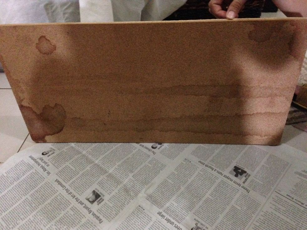 Get an old corkboard and wrap in newspaper.