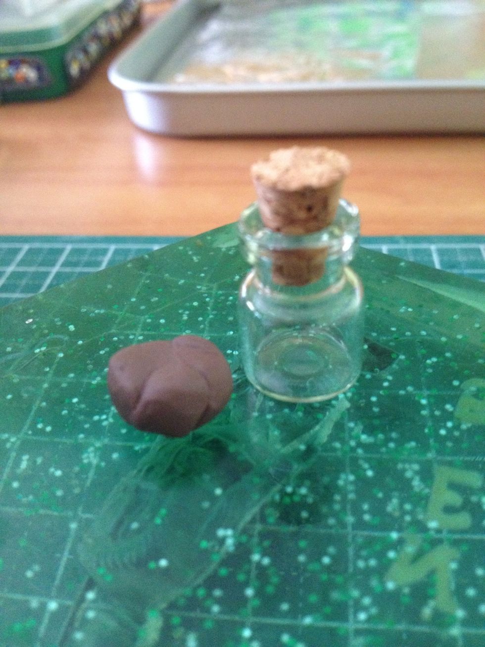 Get brown clay which can cover 1/5 the bottom of the jar. This will be the 'soil'.
