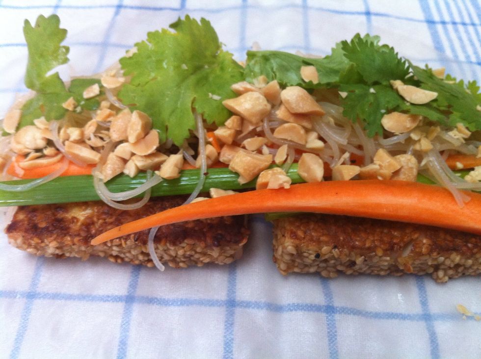Get creative. Put tofu, noodles, slices of carrots, slices of spring onions (green part), chopped peanuts and cilantro on the rice wrappers. Make sure you have enough space left to roll them properly.