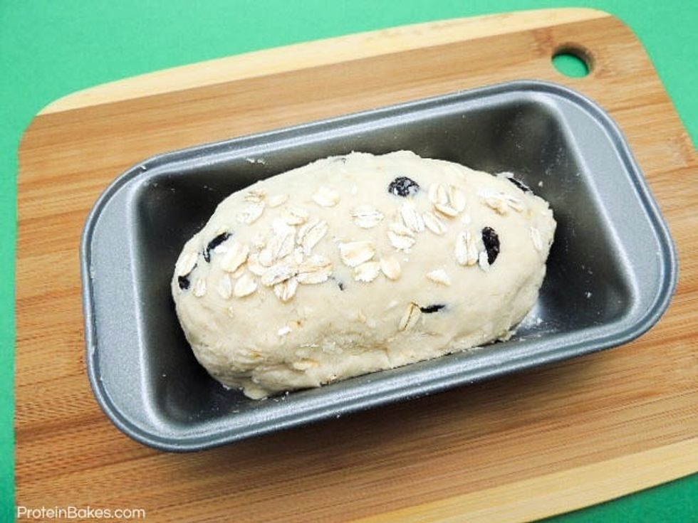 Get loaf pan, sprinkle a bit of flour at the bottom (optional). Pack dough into the loaf pan in a desired form. Add little bit oats on top for decoration (optional).