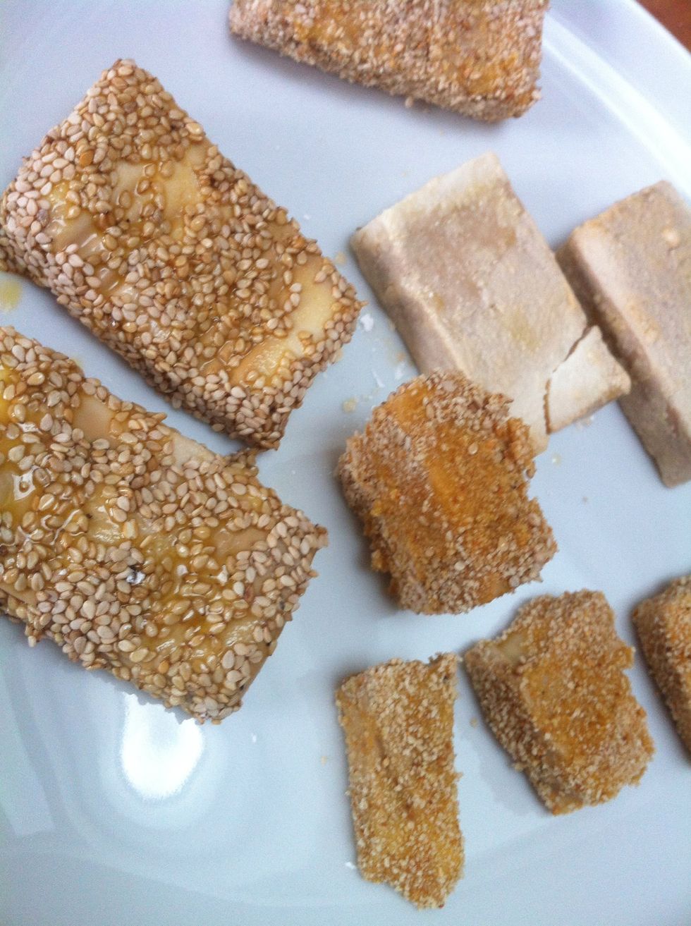 Get messy. Coat the tofu slice with corn starch, then pull it through the whisked egg and coat the slice with bread crumbs or sesame seeds.