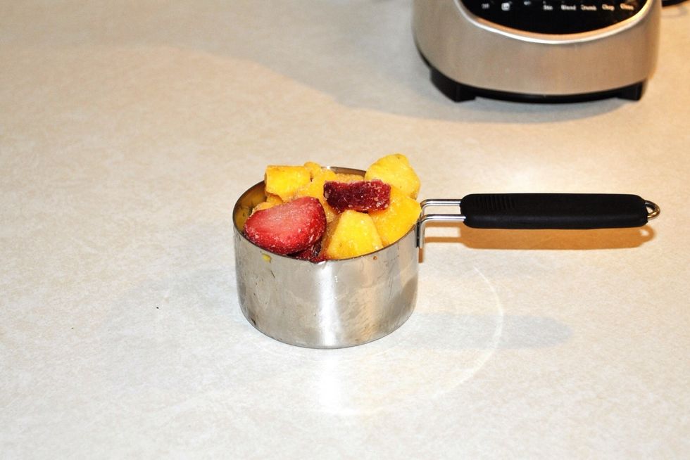 Get one heaping scoop of the *frozen* mixed fruit. The mix should have strawberry, mango, pineapple and peach at the minimum.