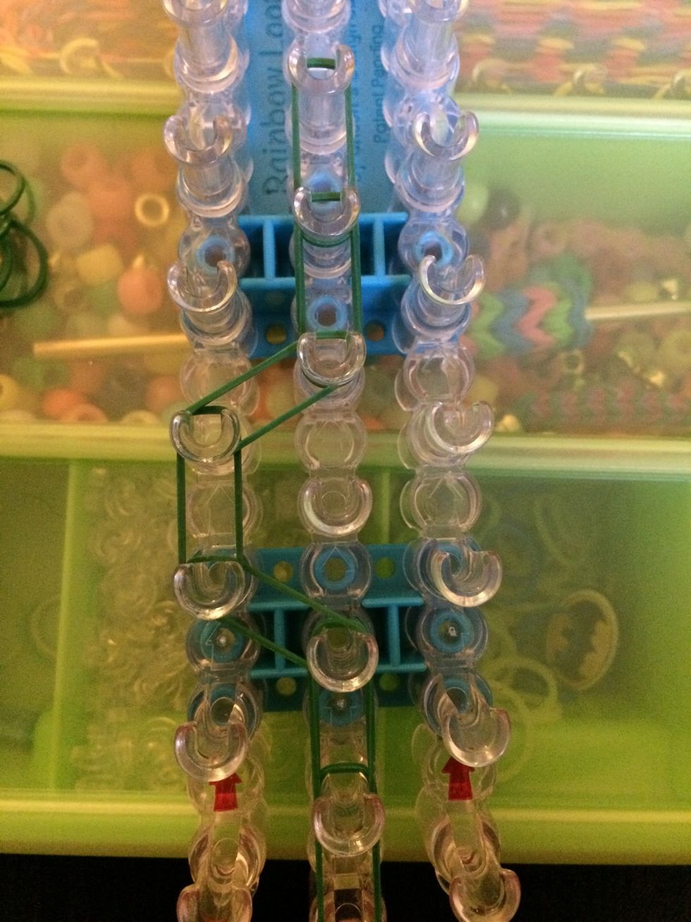 Get one more band and place it to the right. Finish placing bands around in a circle in a clockwise position.